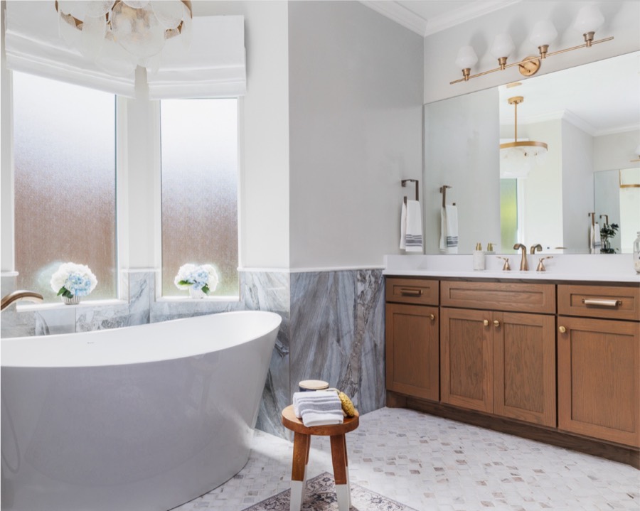 Marble soaking tub and wood vanity