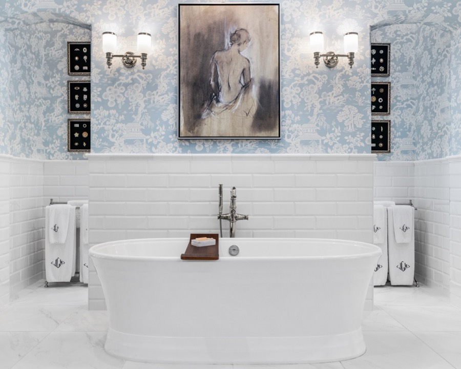 Luxury soaking tub in a toile wallpaper bath