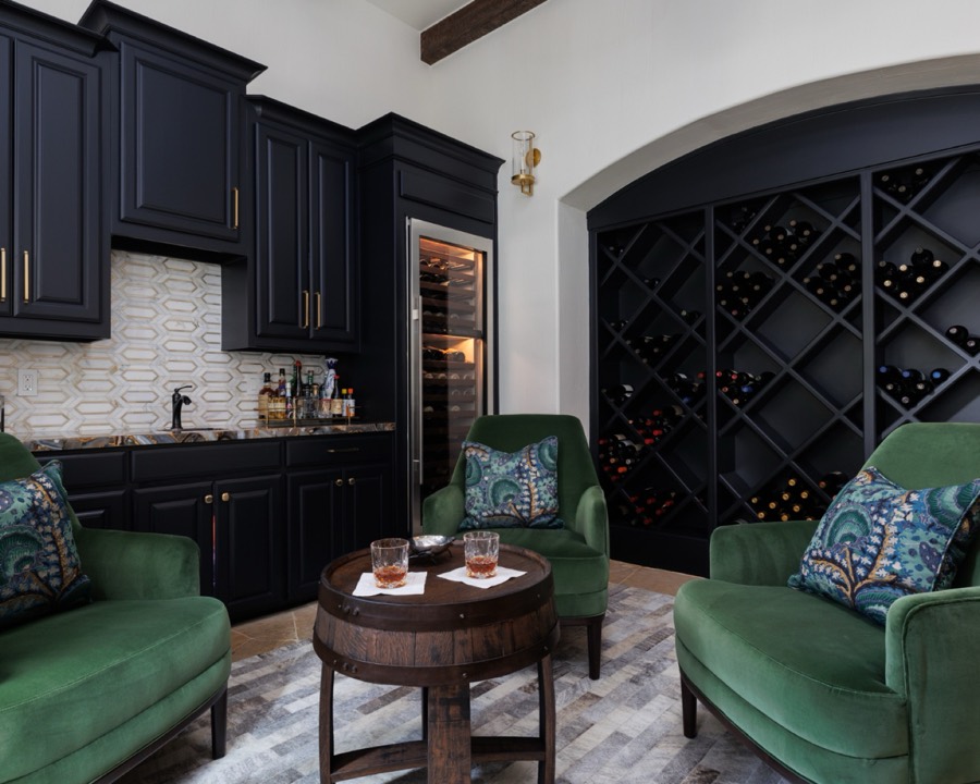 Wine room with green velvet chairs